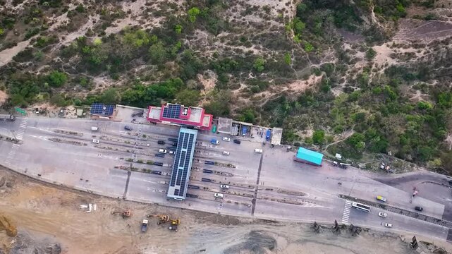 Drone shot of cars passing through highway toll booths with FASTag