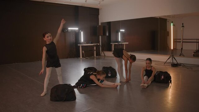 Athletic young girls in a ballet studio preparing for a recital