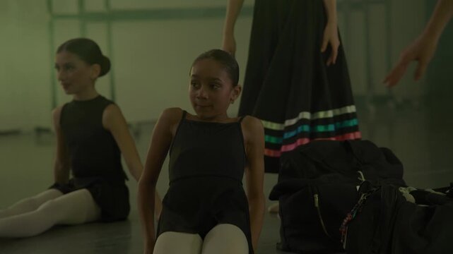Athletic young girls in a ballet studio preparing for a recital