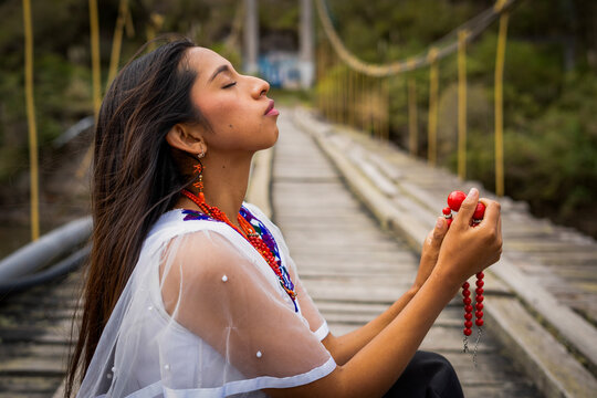 Indigenous woman meditating spiritual moment on a suspension bridge