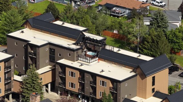 Aerial of modern residential complex near Kellogg Idaho showing multistory apartments and surrounding pine trees