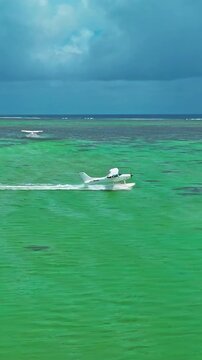 Aerial view of hydroplane is taking off or landing on a crystal clean water. Mauritius