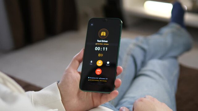 Active call with a taxi driver on a smartphone. The screen displays a timer and indicates the cab will arrive in 2 minutes. Perfect for ride-sharing apps, transportation, and urban mobility content.