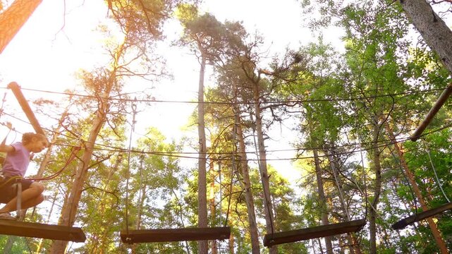 Small girl with helmet in adventure park
