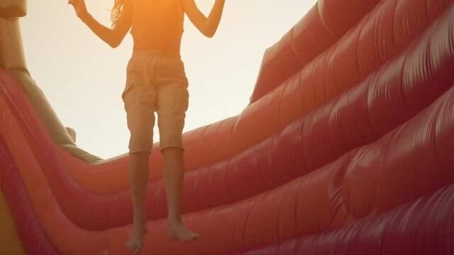 Little girl jumping on an inflatable trampoline
