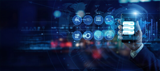 Fototapeta premium Senior data scientist holding a mobile phone analyzing global Big Data analytics on a holographic world map. Futuristic technology, secure network connections, and advanced data visualization.