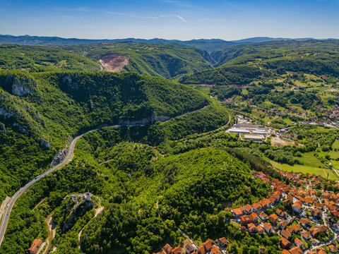 View of the hills and valley in Uzice Zlatibor District with roads and buildings on a sunny day in Serbia