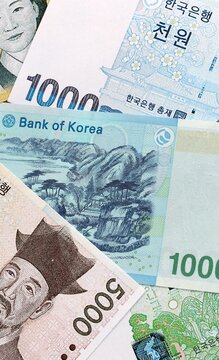 South Korean won money banknotes pile on table. South Korea bills of KRW currency close up