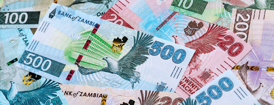 Zambian kwacha money banknotes pile on table. Zambia bills of ZMW currency close up