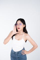 Naklejka premium Happy young asian woman wearing glasses and casual with surprised or wow and shocked face expression isolated on white background. 