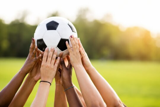 Smiling Woman Football Fan Holding Ball Beside Clean Wall