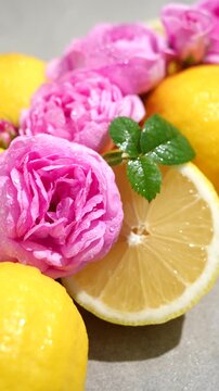 Lemons and pink roses with water droplets, a concept of freshness and purity