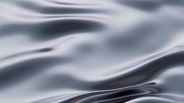 Slow motion close up pan of metallic liquid surface rippling across seamless studio tabletop under soft studio lighting with glossy reflective texture
