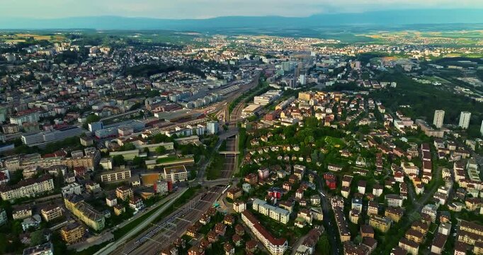 Establishing shot of swiss city Lausanne in summer day. Aerial view of the Switzerland city on the shores of Lake Geneva