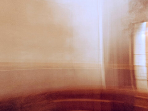 Abstract interior motion blur background, intentional camera movement icm with warm beige and brown tones, soft architectural panning line texture
