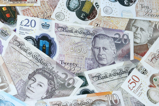 British pound money bills in pile on table. United Kingdom GBP currency cash