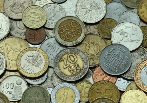 Big pile of coins from different money currencies. Treasure and numismatics concept