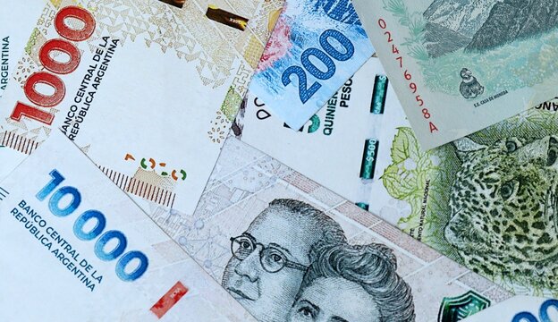 Argentine peso money bills in pile on table. Argentina ARS currency cash close up