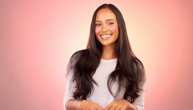 Smiling young woman with long dark hair posing against pink gradient background