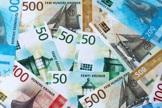 Norwegian krone money bills in pile on table. Norway NOK currency cash close up
