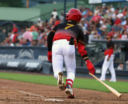 baseball player running to first base