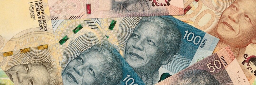 South African rand money bills in pile on table. South Africa ZAR currency cash close up