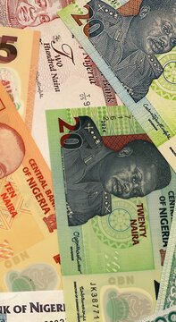 Nigerian naira money bills in pile on table. Nigeria NGN currency cash close up