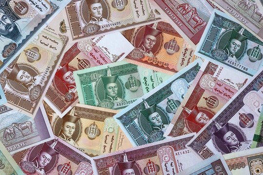 Mongolian tugrik money bills in pile. Big amount of Mongolia MNT currency cash close up