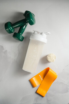Home workout essentials with protein powder and shaker bottle