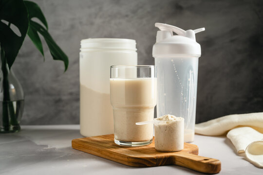 Protein shake with whey powder and shaker bottle, sports nutrition supplement concept