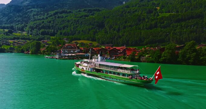 Aerial view of steamboat ship in lake with Swiss Flag. Beautiful Swiss Alps nature in summer Switzerland with turquoise blue lake water