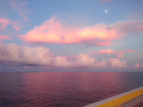 Sunrise over the ocean as viewed from a Cruise ship, a beautiful skyscape of clouds  and sunlight .