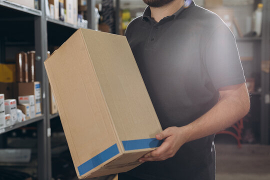 Delivering auto parts box in car repair shop