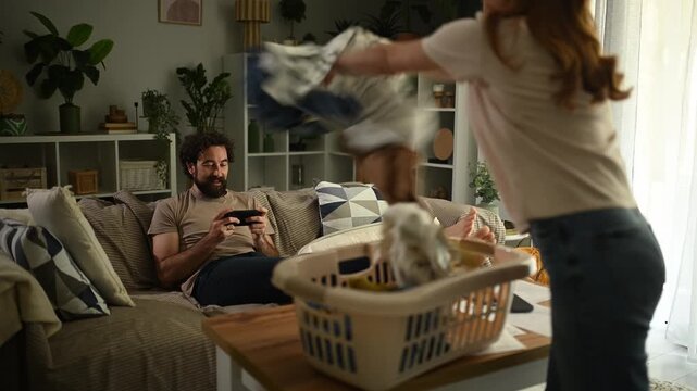 Frustrated woman arguing with her boyfriend for not helping with chores. Couple conflict over housework and unequal relationship duties