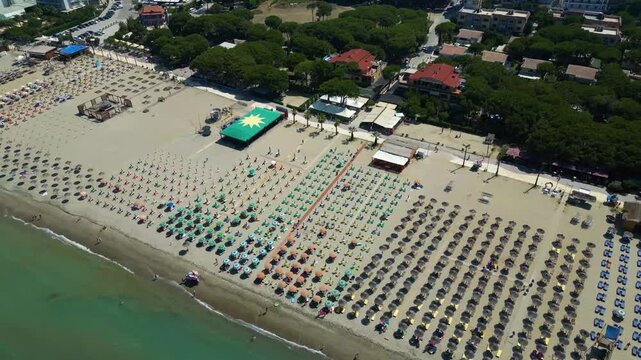 Aerial View of a Crowded Sandy Beach Packed with Rows of Colorful Sun Umbrellas and Loungers