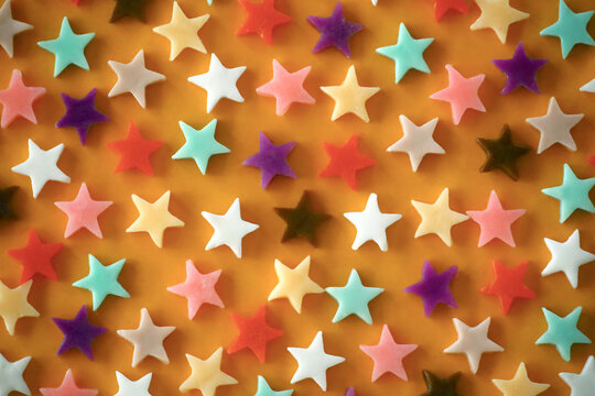  Colorful star-shaped chocolates flat lay background
