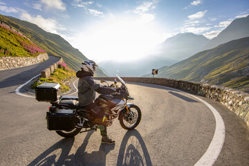 Motorcycle rider riding in Italian Alps during sunrise © Lukas Gojda