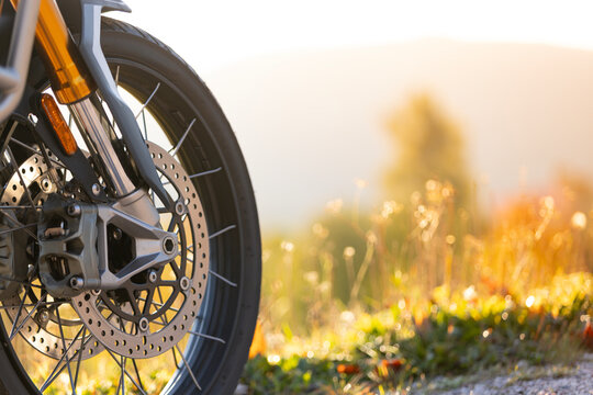 Close-up of motorcycle wheel on empty road