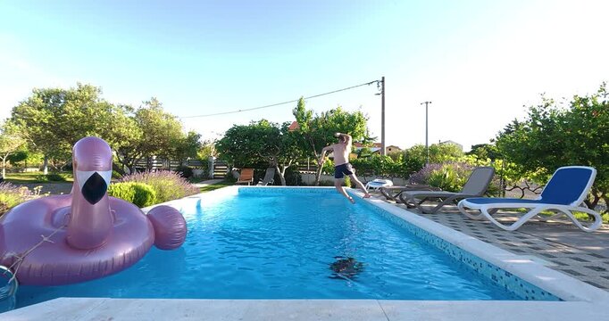 Man stumbles near the edge of a swimming pool and accidentally falls into the water. Humorous summer moment captured outdoors with leisure, fun, and unexpected action.