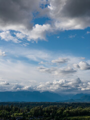 Fototapeta premium Dramatic Cloudy Sky Over Fraser Valley Mountains and Lush Forest Landscape in BC Canada