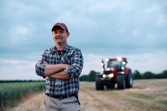 Portrait of confident farm owner in field looking at camera.