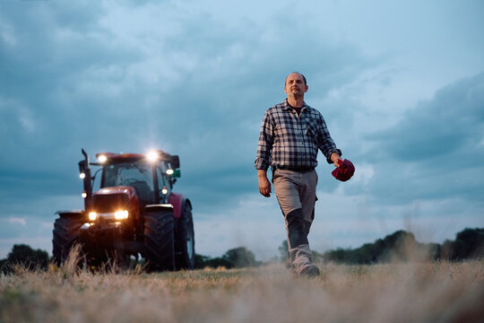 Below view of mature farmer walking in field.