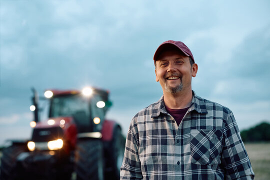 Happy mature agricultural worker looking at camera.