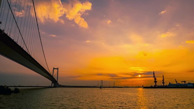Suspension Bridge Over Water at Sunset