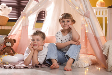 Little girl and boy near wigwam at home © New Africa
