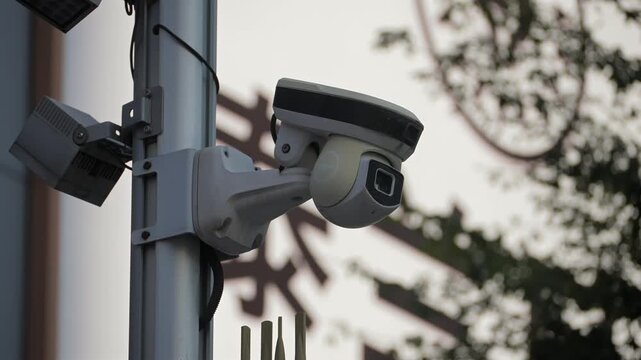 Many Street surveillance Cameras in Shenzhen, China. Enforcement cameras mounted on a pole overlooking a residential street for public safety and urban monitoring