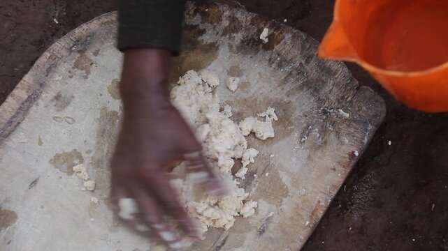 Dorze woman is preparing dough for kocho bread made of enset (false banana), important source of food, Ethiopia