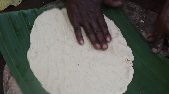 Dorze woman is preparing kocho bread made of enset (false banana), important source of food, Ethiopia