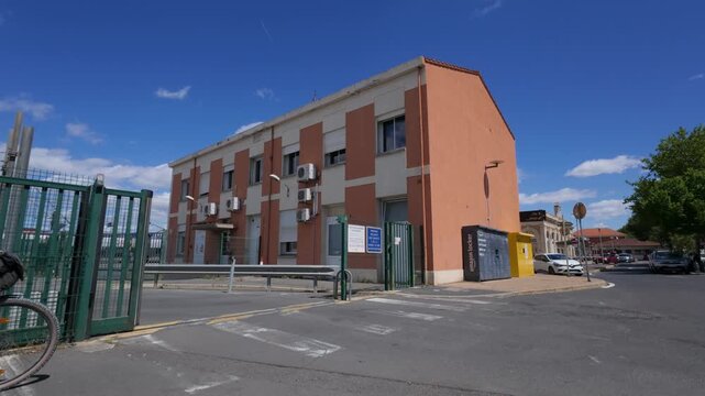 Orange industrial building with parcel locker and closing gate warehouse logistics