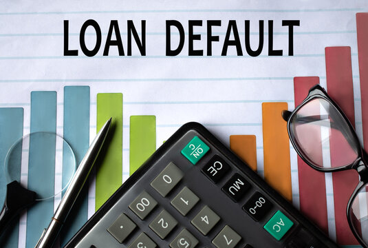 LOAN DEFAULT - words on a color chart with a calculator, magnifying glass and glasses